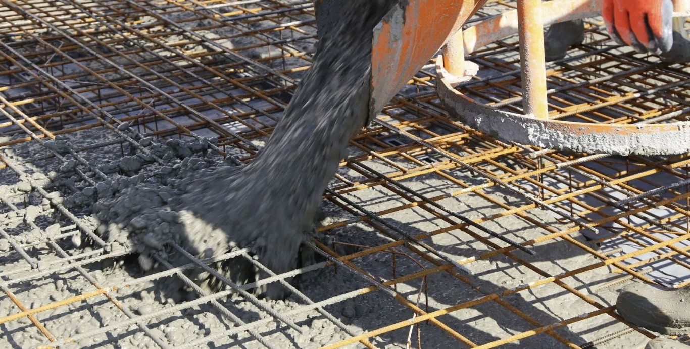 Concrete being poured over reinforced rebar mesh for structural strength in Hollister, CA